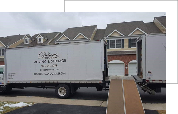 Two moving vans with a ramp in between them